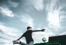 man playing soccer during daytime